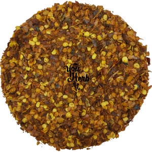 May include: Close-up of crushed red pepper flakes. The flakes are a mix of red, orange, and yellow. The flakes are small and irregular in shape.