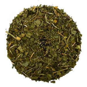 May include: A circular pile of dried green herbs and leaves, with some yellow and brown pieces mixed in. The text "You Herb It" is visible in the center of the image. The herbs are likely for culinary or medicinal use.