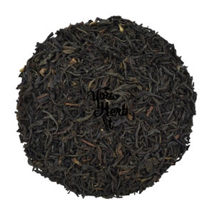 May include: Loose black tea leaves, a blend of black tea and other ingredients, for brewing a cup of tea.