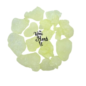 May include: A collection of pale yellow, irregularly shaped resin pieces arranged in a circular pattern against a white background. The text "You Herb It" is displayed in a stylized font.