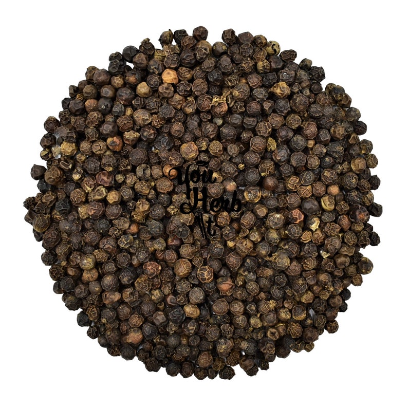 May include: A close-up view of a large pile of black peppercorns. The peppercorns are round and have a slightly wrinkled texture.