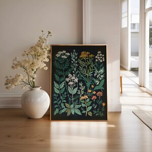 May include: A framed botanical print featuring a variety of green plants and flowers on a black background. The flowers are in shades of white, yellow, orange, and pink.
