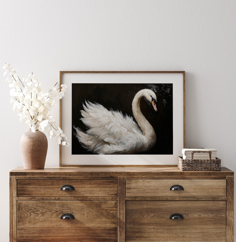 May include: A framed painting of a white swan with its head turned to the side, against a dark background.