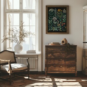 May include: A vintage-style chest of drawers with four drawers, a light wood finish, and brass hardware. The chest of drawers is in a room with a large window, a chair, and a framed botanical print on the wall.