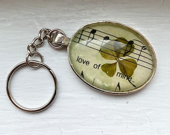 Genuine four-leaf clover keychain with Beatles sheet music ("love of mine")