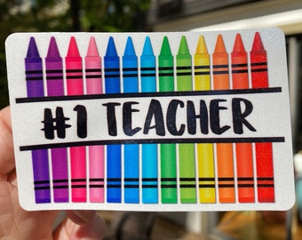 Number 1 Teacher Sticker (59N) with split Crayons in a line printed on white glitter, permanent adhesive, waterproof ink