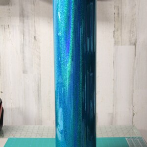 May include: A roll of teal iridescent glitter vinyl with a holographic finish.