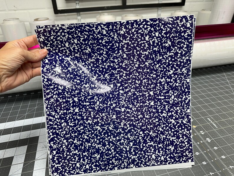 May include: A stack of blue and white patterned vinyl sheets. The pattern resembles the paper of a composition notebook.