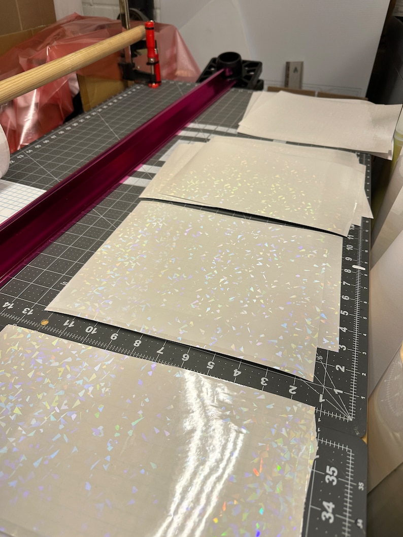 May include: Four sheets of iridescent white vinyl with a holographic finish. The vinyl is cut to size and ready to be used for crafting projects.
