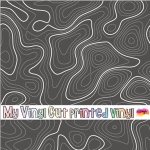 May include: Dark gray vinyl with a white topographic map design. The image features a repeating pattern of contour lines, creating a textured effect. The text "My Vinyl Cut printed Vinyl" is displayed at the bottom.