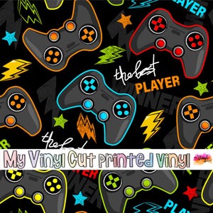 May include: Black background with a pattern of gray video game controllers in various colors, including orange, blue, and green. The text "the best PLAYER" is also visible, along with stars and lightning bolt graphics.