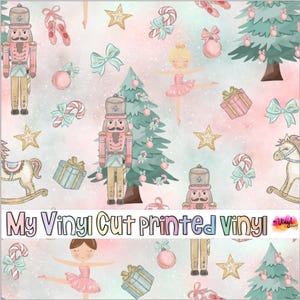 May include: A seamless pattern featuring a pink and blue watercolor background with a variety of Christmas-themed illustrations, including nutcrackers, ballerinas, candy canes, Christmas trees, and presents. The text "My Vinyl Cut Printed Vinyl" is displayed at the bottom of the image.