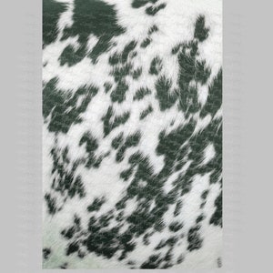 May include: A close-up of a white and black spotted pattern, resembling animal fur. The black spots are irregularly shaped and scattered across the white background, creating a textured appearance. The pattern is likely used for decorative purposes.