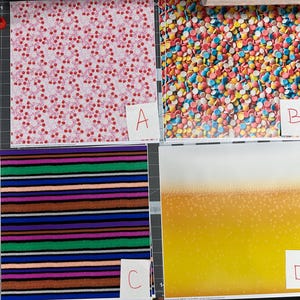 May include: Four patterned papers are displayed. Paper A has a white background with a repeating pattern of red cherries. Paper B is covered in colorful candy sprinkles. Paper C features horizontal stripes in various colors. Paper D has a gradient of yellow to white.
