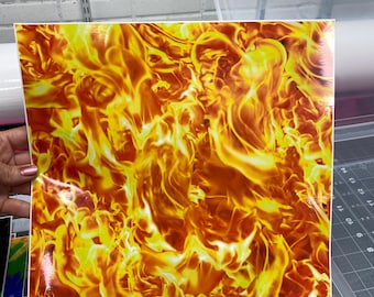 May include: A square sheet with a vibrant flame pattern in shades of yellow, orange, and red. The design mimics the look of fire. The sheet is held up against a white background.