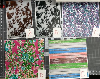 May include: Five patterned paper sheets are displayed. The patterns include cowhide, paisley, and floral designs in various colors. One sheet features a wood plank design. Each sheet is labeled with a letter from A to E.