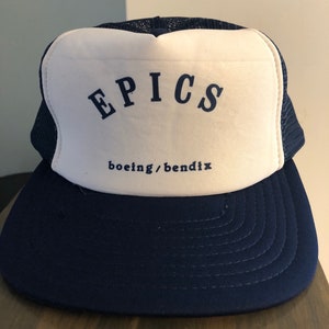 May include: A blue and white trucker hat with the word "EPICS" in navy blue lettering and the text "boeing/bendix" in smaller navy blue lettering.