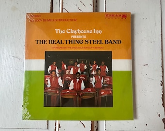 The Clayhouse Inn presenta The Real Thing Steel Band LP Bermuda Coca Cola Shrink Wrapped 1980