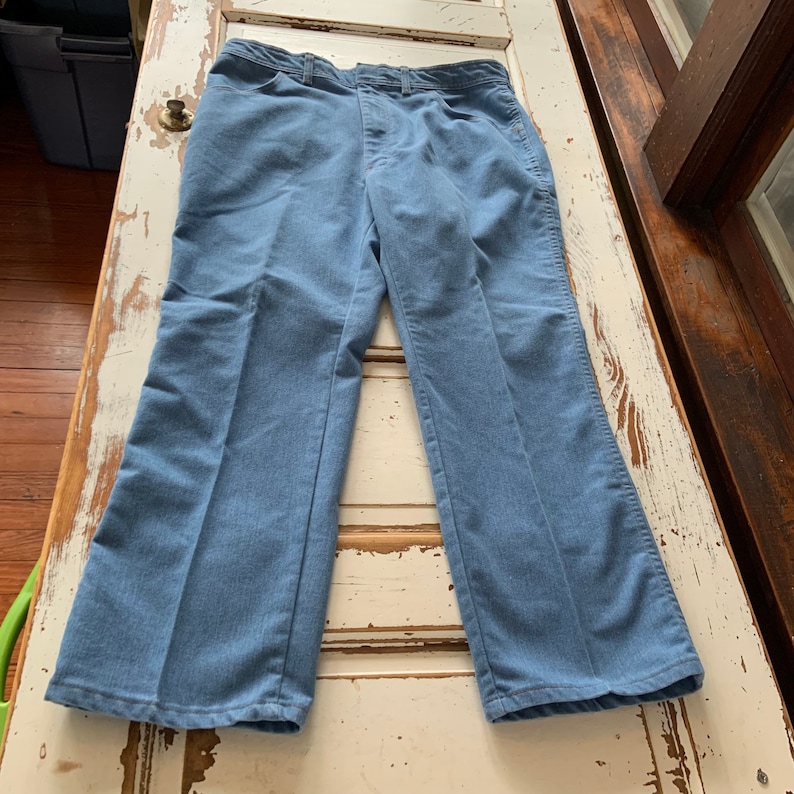 May include: A pair of light blue denim pants with a straight leg fit.