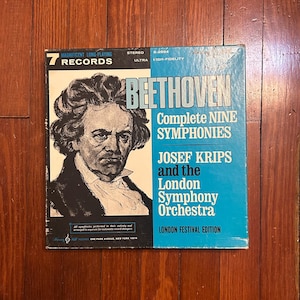 May include: Vintage vinyl record album cover featuring a portrait of Beethoven. The album is titled "Complete Nine Symphonies" by Josef Krips and the London Symphony Orchestra. The cover has a blue and white color scheme and includes the text "7 Records".