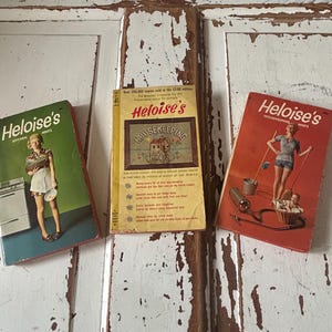May include: Three vintage "Heloise's Hints" books. The covers are in green, yellow, and red, each featuring illustrations of a woman. The green book is titled "Heloise's Kitchen", the yellow book is titled "Heloise's Housekeeping Hints", and the red book is also titled "Heloise's Housekeeping Hints".