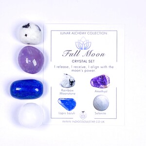 May include: A Full Moon crystal set featuring four polished stones: rainbow moonstone, amethyst, lapis lazuli, and selenite. The set includes a card with the text "Full Moon Crystal Set" and the website address www.indigosoulstar.co.uk.