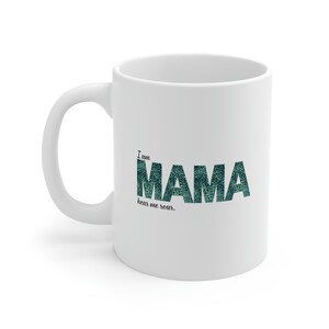 May include: White ceramic coffee mug with a green and black graphic that says "I am Mama hear me roar."