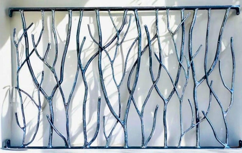 May include: A decorative metal gate with a tree branch design. The gate is made of dark blue metal and features a series of intertwined branches, creating a natural and artistic look. The gate is suitable for outdoor use.