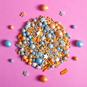 Blue, orange and silver cake sprinkles featuring edible stars, sugar strands, nonpareils and pearls.