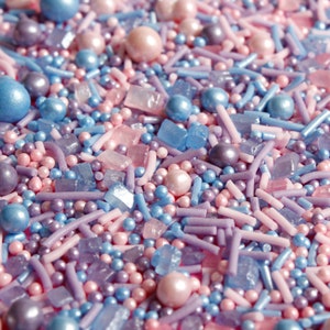 Purple, pink and blue cake sprinkles featuring edible sugar crystals, strands, nonpareils and pearls.