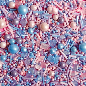 Purple, pink and blue cake sprinkles featuring edible sugar crystals, strands, nonpareils and pearls.