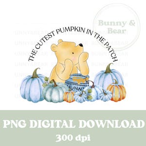 May include: A digital illustration of Winnie the Pooh, a yellow bear, holding a blue pot of honey. The bear is surrounded by blue and orange pumpkins with green leaves. The text "The Cutest Pumpkin in the Patch" is written in a circle around the bear. The text "Bunny & Bear" is written in a circle in the upper right corner of the image.
