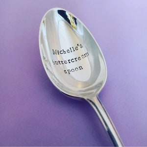 May include: A silver spoon with the text "Michelle's buttercream spoon" engraved on the bowl.