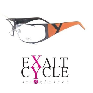 May include: Spectacles with a dark grey frame and bright orange temples featuring a black Y-shaped accent. The lenses are clear and include the text EXALT CYCLE printed on the right lens. Below the glasses is the logo EXALT CYCLE sun & glasses.
