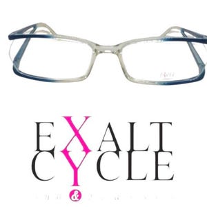 May include: Rectangular spectacles with a clear frame that transitions into a dark blue gradient at the top and bottom edges. The right lens features the text RWI. Below the glasses is the black and pink text EXALT CYCLE with an ampersand.