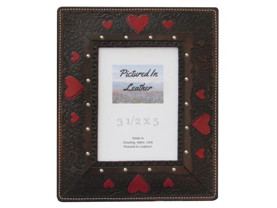 A beautiful leather picture frame, in a 3-1/2x5 size, handmade, with hand painted red hearts, great leather anniversary gift