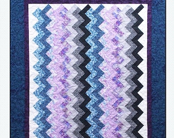 May include: A quilting pattern called "Tipsy" by Pressed For Time Quiltworks. The pattern is a fat-quarter friendly design featuring a chevron pattern in shades of blue, purple, and black.