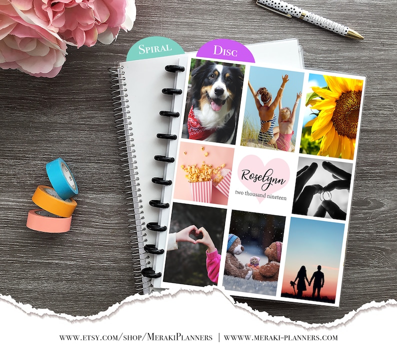May include: A white spiral-bound planner with a disc-bound section featuring photos and the text "Roselynn two thousand nineteen." Colorful washi tape and a pen are also visible. The planner is on a dark wood surface.