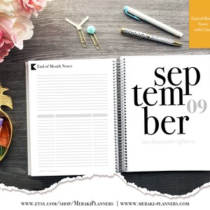 May include: Open planner with the month of September displayed, featuring the date '09' and the year 'two thousand eighteen'. The left page has 'End of Month Notes' and lined sections. Gold and turquoise paper clips and pens are on the wooden surface.