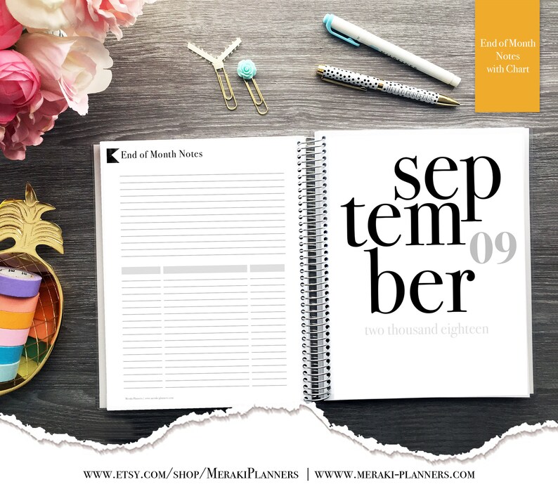 May include: Open planner with the month of September displayed, featuring the date '09' and the year 'two thousand eighteen'. The left page has 'End of Month Notes' and lined sections. Gold and turquoise paper clips and pens are on the wooden surface.