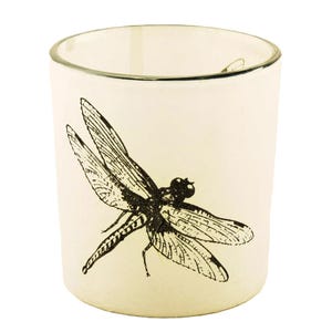 May include: A white glass candle holder with a black and white dragonfly design.
