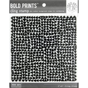 May include: A black and white cling stamp with a repeating triangle pattern. The stamp is labeled "BOLD PRINTS" and "cling stamp". The stamp is 6 x 6 inches and is designed for cardmaking.