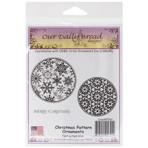 May include: A white package featuring a black and white image of two Christmas ornaments. The package is labelled "Our Daily Bread designs" and "Merry Christmas". The text "Item#F500" is also visible on the package.