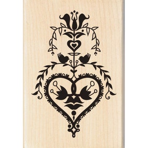 May include: Black and white wood mounted rubber stamp with a folk art design of a heart with two birds and a stylized flower.