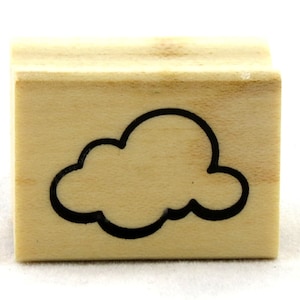 May include: A wooden stamp with a black outline of a cloud. The stamp is rectangular and has a light brown color.