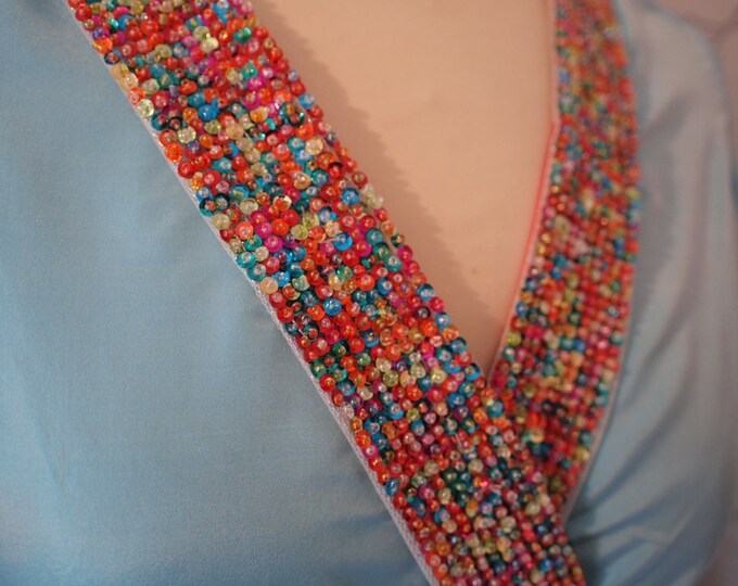 White ribbon embroidered with multicolored beads and sequins, sold in 25cm lengths