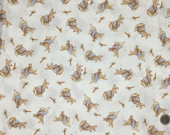May include: White fabric with a repeating pattern of cartoon rabbits wearing blue vests and carrying carrots. The rabbits are in various poses, and the carrots are scattered across the fabric. The overall design is whimsical and suitable for children's items.