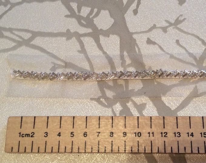 White ribbon embroidered with beads, sold by the meter