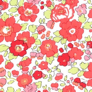 May include: A floral fabric design with a white background, covered in red and pink flowers, and yellow-green leaves. The pattern is dense, with a variety of flower sizes. The overall effect is a bright and cheerful floral print.