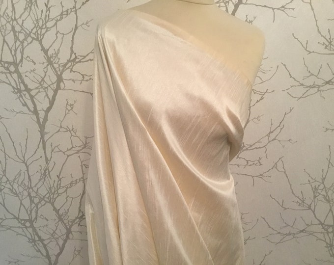 Faux taffetas dupioni silk fabric. Color Cream or ivory.